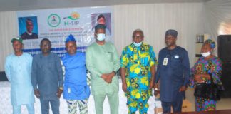 Fourth left: Representative of the Honourable Minister of Humanitarian Affairs, Disaster Management and Social Development, Babatunde Jaji, Second left, Representative of the State Focal Person, Barrister Silvanus Iyang, First right, Conditional Cash TransferChairperson, Godwin Achoda, Third right NHGSFP Chairperson Gabriel Okulaja, Third left NOA Assime Usetu Ogban and others during the IMs Flag Off and Distribution of Engagement Letters and Tablets in Ministry of Finance Government, Hall Calabar, Cross River State July 3, 2021.