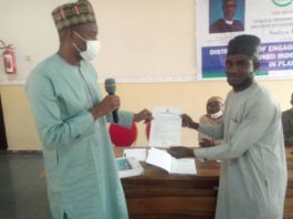 The Representative of the Honorable Minister of Humanitarian Affairs, Disaster Management and Social Development Deputy Director Humanitarian Affairs Department, Dr. Abubakar Suleiman and an independent Monitor receiving a tablet and engagement letter during the flag off of the Programme in Plateau State 6th July, 2021.