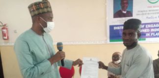 The Representative of the Honorable Minister of Humanitarian Affairs, Disaster Management and Social Development Deputy Director Humanitarian Affairs Department, Dr. Abubakar Suleiman and an independent Monitor receiving a tablet and engagement letter during the flag off of the Programme in Plateau State 6th July, 2021.