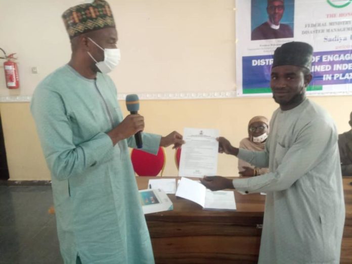 IMG-20210707-WA0001 The Representative of the Honorable Minister of Humanitarian Affairs, Disaster Management and Social Development Deputy Director Humanitarian Affairs Department, Dr. Abubakar Suleiman and an independent Monitor receiving a tablet and engagement letter during the flag off of the Programme in Plateau State 6th July, 2021.