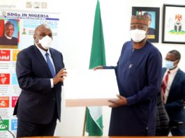 PRESIDENT OF AFREXIMBANK, PROF. BENEDICT ORAMAH (L) PRESENTING A SOUVENIR TO SGF, BOSS MUSTAPHA