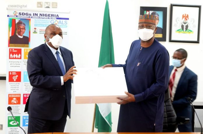 PRESIDENT OF AFREXIMBANK, PROF. BENEDICT ORAMAH (L) PRESENTING A SOUVENIR TO SGF, BOSS MUSTAPHA