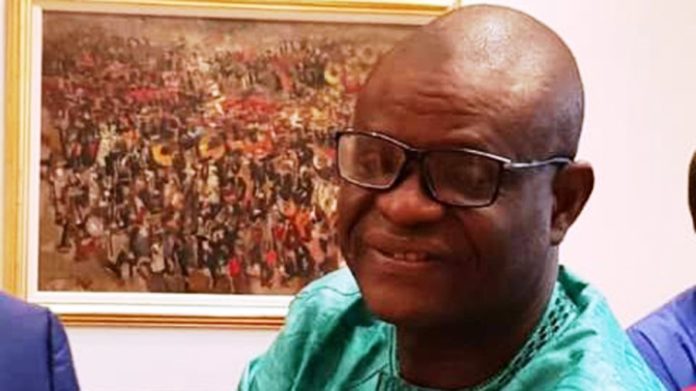 President Buhari greets IPI Secretary, Raheem Adedoyin at 60