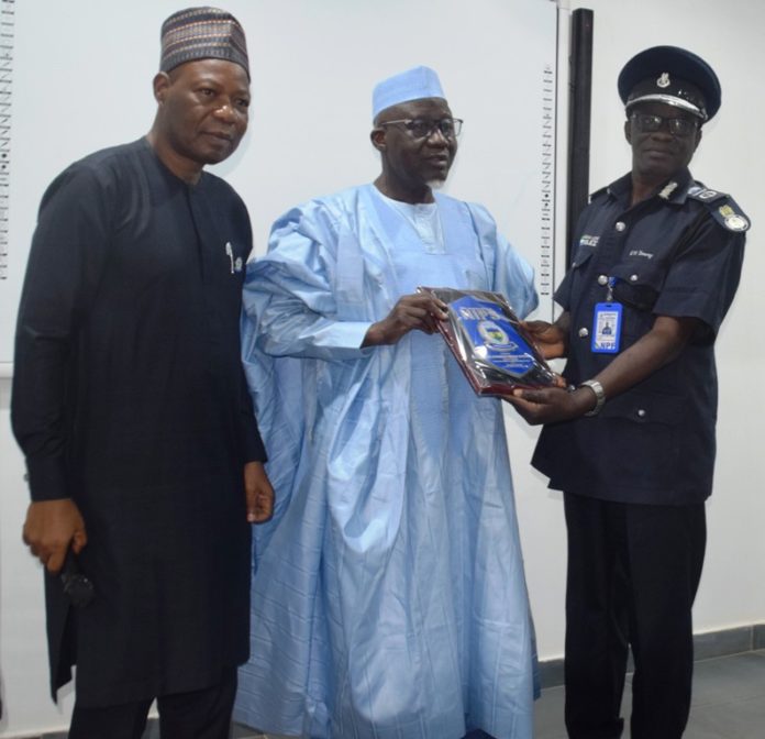 L-R: Director-General, National Institute of Police Studies, Prof. Olu Ogunsakin, Minister of Police Affairs, Muhammad Maigari Dingyadi and AIG Gabriel. N. Tommy (Sierra Leon) during the presentation of plague by course participants of the Strategic Leadership and Command Course 3/2021 at the National Institute of Police Studies in Abuja.