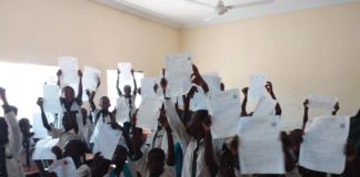 Pupils displaying their from as they want to be captured in Popmmari Pry Sch, 1000 Housing Estate, Konduga LGA, Borno State.