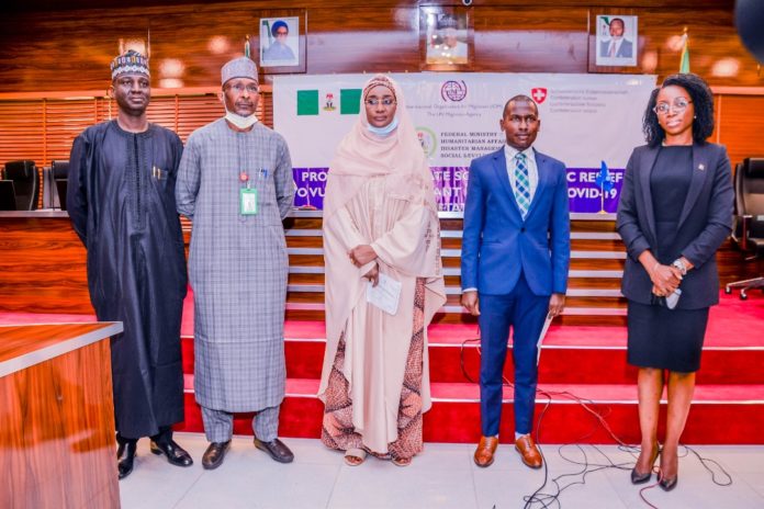 IMG-20210817-WA0000 (3rd Right) The Honourable Mister of Humanitarian Affairs, Disaster Management and social Development, Sadiya Umar Farouq, (2nd Left) the Permanent Secretary of the Ministry, Bashir Nura Alkali, (1st Left) Director Humanitarian Affairs, Grema Ali Alhaji, (2nd Right) Chief of Mission, IOM, Mr Frantz Celestin, Representative of the Ambassador, Embasy of Switzerland, Ojoma Ali, during the Official Launch of The Project ` Providing Immediate Socio-Economic Relief To Vulnerable Migrant Impacted by Covid-19 in Nothern States of Nigeria` , on the 12th August, 2021. in Abuja