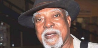 President Buhari greets Poet, Author, Journalist, Lindsay Barrett at 80