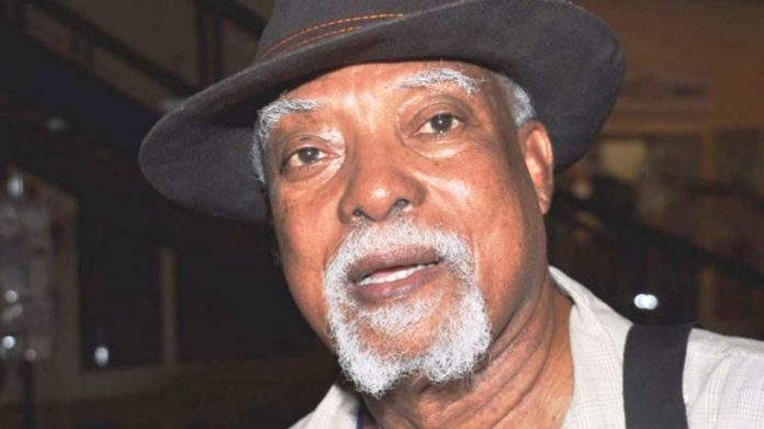 President Buhari greets Poet, Author, Journalist, Lindsay Barrett at 80