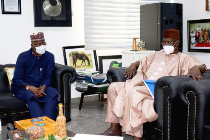 SGF, Boss Mustapha (L) conversing with Gov. Abdullahi Sule