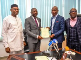 The Event of Signing of MoU between the Federal Ministry of Youth & Sports Devlpt. and the KONGA Group; inside the office of the Hon. Minister @ the Moshood Abiola National Stadium, Abuja. Holding the signed MoU is the Hon. Minister, Mr Sunday Dare ( in Grey Suit); with Mr. Leo Stan Eke, President of KONGA Group ( in a Blue Blazer Jacket) ; Supporting the Hon. Minister is the Permanent Secretary of the Ministry, Mr Nebeolisa Anako; extreme right is KONGA Official.