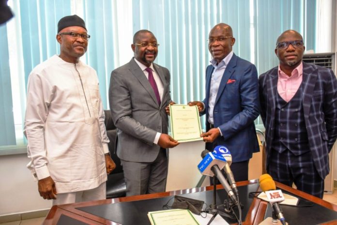 Signing of MoU between the Federal Ministry of Youth & Sports Devlpt. and the KONGA Group The Event of Signing of MoU between the Federal Ministry of Youth & Sports Devlpt. and the KONGA Group; inside the office of the Hon. Minister @ the Moshood Abiola National Stadium, Abuja. Holding the signed MoU is the Hon. Minister, Mr Sunday Dare ( in Grey Suit); with Mr. Leo Stan Eke, President of KONGA Group ( in a Blue Blazer Jacket) ; Supporting the Hon. Minister is the Permanent Secretary of the Ministry, Mr Nebeolisa Anako; extreme right is KONGA Official.