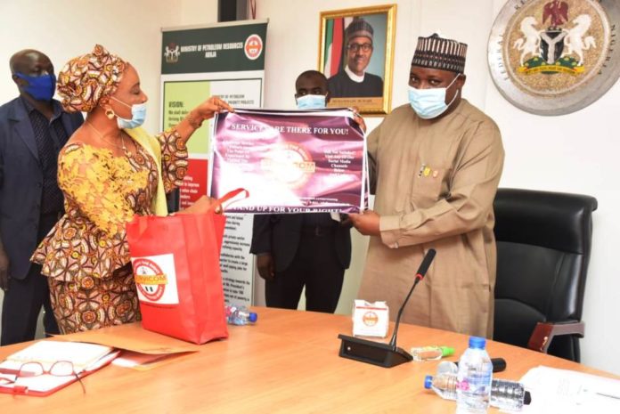 The National Coordinator/CEO SERVICOM, Mrs Nnenna Akajemeli presenting items from Servicom to the PS, Dr. Nasir Sani Gwarzo, mni, NPOM