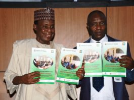 Minister of Defence, Maj Gen Bashir Salihi Magashi (L) and the Permanent Secretary, Musa Istifanus (R) with the SSD manual