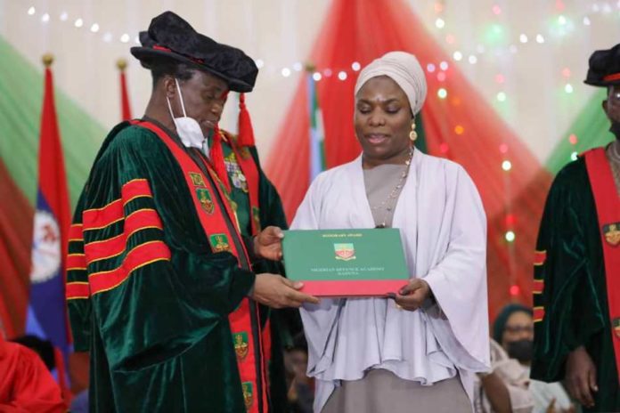 combined Convocation of the 68 Regular Course of Cadets of Nigerian Defence Academy (NDA) and Post Graduate Students he Minister of Defence presenting the Honorary Degree to the immediate past Chief of Army Staff, Late Lt Gen Ibrahim Attahiru' s widow.