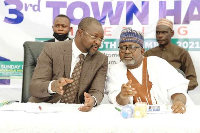 Hon Minister of Youth & Sports Devlpt. Mr Sunday Dare in a banter with the Permanent Secretary, Alhaji Ismail Abubakar during the TownHall meeting