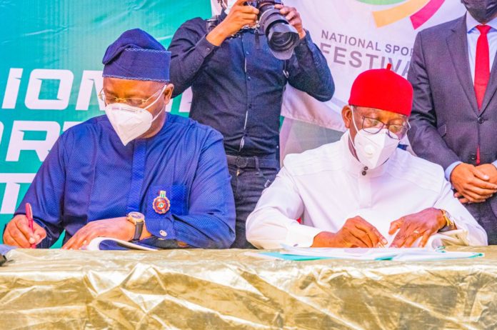Hon. Minister of Youth and Sports Development, Chief Sunday Dare and Delta State Governor, Dr Ifeanyi Okowa sign MoU on National Sports Festival 2022 during the Extra Ordinary National Council on Sports Meeting in Asaba on Monday, 20th December, 2021