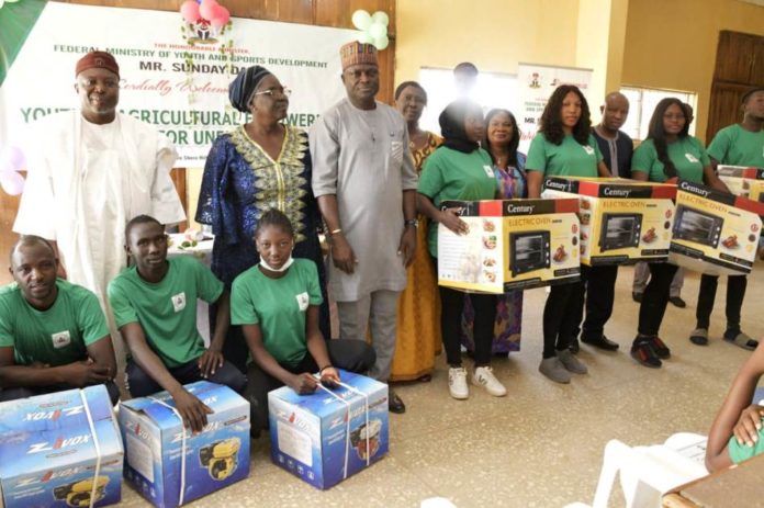 L-R, District Head of Gwafan, Danladi Kaze, Rep by Adagwom Izere Chiefdom, Jos north; Ada Emmanuel Ajik, Zonal Coord, Fed. Ministry of Youth & Sports Devpt (North Central), Mrs. Deborah Pitman, Rep of the Minister of Youth and Sports Devpt, Mr Sunday Dare and Director, Enterprise Devpt and Promotion Dept, Olugbenga Momoh, Perm Sec, Plateau State Ministry of Youth & Sports Devpt, Mrs. Helen Ishaya and some participants with their starter packs at the end of the 2-week Nat. Youth in Agriculture Empowerment Training Programme organised by the Ministry for youth in the 36 States including Abuja at Jos, Plateau State over the weekend