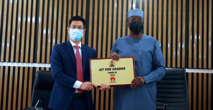 SGF, Boss Mustapha (R) and MD, Huawei, Mr. Trevor Liu displaying a souvenir on ICT for Change after signing the MoU
