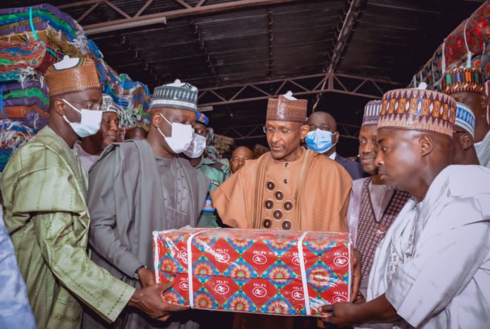 IMG-20220401-WA0000 (3rd Left) The Representative of the Honourable Minster of Humanitarian Affairs, Disaster Management and Social Development, Sadiya Umar Farouq, the Permanent Secretary of the Ministry, Bashir Nura Alkali, (2nd Left) The Representative of the Governor of Borno State, the Deputy Governor of the State, His Excellency Umar Usman Kadafur, (1st Left) Director Humanitarian Affairs, Grema Ali Alhaji, and others, during Hand-over of Recovery Needs Items for IDP's. On 30th March, 2022. In Maiduguri.