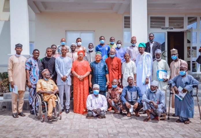 IMG-20220405-WA0024 (2nd Row) (5th Left) The Representative of the Honourable Minster, Federal Ministry of Humanitarian Affairs Disaster Management and Social Development, Sadiya Umar Farouq, Director Special Needs Nkechi Onwukwe, (4th Left) Representative of the Permanent Secretary of the Ministry, David Onah, (6th Left) Representative of the Honourable Commissioner, Federal Ministry of Women Affairs and Social Development, Acting Permanent Secretary, Aleni Emmanuel Allenclay, (3rd Right) Consultant Bengner Engineering Ltd, Lanre Oloruntobe, and others, during the opening of the 3-day Capacity Building Worshop for Identified Local Producers of Assistive Technologies in the 36 States and FCT. On the 5th April, 2022. In Lokoja.