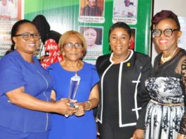 The Permanent Secretary FMWR Mrs Didi Walson-Jack mni, flanked by Engr Ebele Okeke FNSE CFR and others while receiving her award.