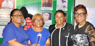 The Permanent Secretary FMWR Mrs Didi Walson-Jack mni, flanked by Engr Ebele Okeke FNSE CFR and others while receiving her award.