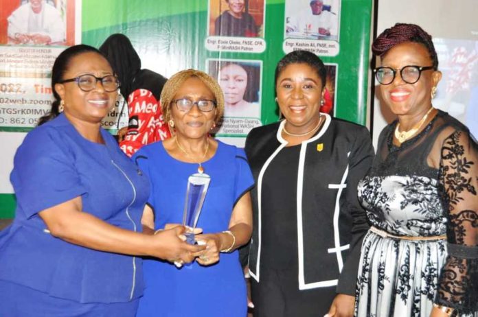 The Permanent Secretary FMWR Mrs Didi Walson-Jack mni, flanked by Engr Ebele Okeke FNSE CFR and others while receiving her award.