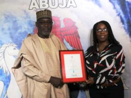 The Honourable Minister of Water Resources Engr Suleiman H Adamu FNSE FAeng being presented the award by the Nigeria Country Director, WaterAid, Mrs Evelyn Mere