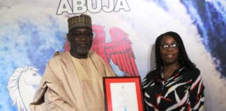 The Honourable Minister of Water Resources Engr Suleiman H Adamu FNSE FAeng being presented the award by the Nigeria Country Director, WaterAid, Mrs Evelyn Mere