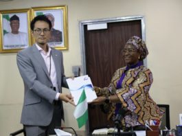 Permanent Secretary, Federal Ministry of Industry, Trade and Investment, Dr. Evelyn Ngige (right), receiving a JICA's Brochure from the Chief Representative of JICA in Nigeria, Mr. Yuzurio Susumu during the courtesy visit to her office, Abuja.