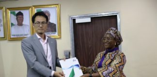 Permanent Secretary, Federal Ministry of Industry, Trade and Investment, Dr. Evelyn Ngige (right), receiving a JICA's Brochure from the Chief Representative of JICA in Nigeria, Mr. Yuzurio Susumu during the courtesy visit to her office, Abuja.
