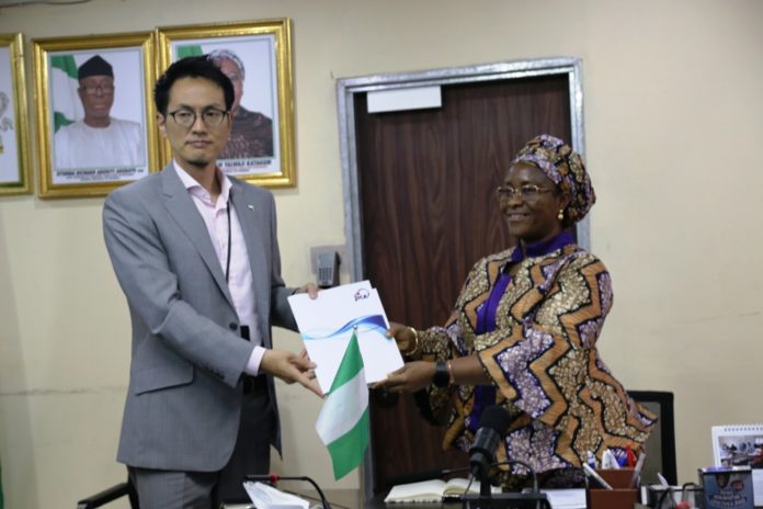 Permanent Secretary, Federal Ministry of Industry, Trade and Investment, Dr. Evelyn Ngige (right), receiving a JICA's Brochure from the Chief Representative of JICA in Nigeria, Mr. Yuzurio Susumu during the courtesy visit to her office, Abuja.