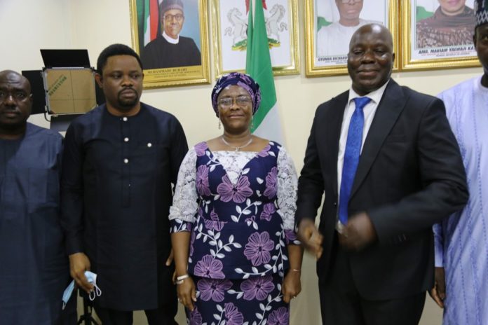 Permanent Secretary of the Ministry, Dr. Evelyn Ngige (centre), flanked to the right by the in-coming Executive Director, Sir. Charles Onyeka Okoye and to her left by the out-going Ag. Executive Director of Lagos International Trade Fair Complex, Mr. Francis Dajilek during the formal handing over ceremony in her Office, Abuja