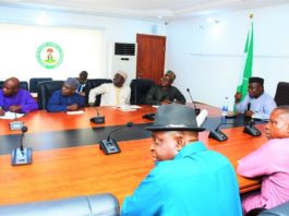 The SGoF, Surv. Adebomehin explaining certain salient areas on a projected Nigeria Administrative Map to the RMAFC team