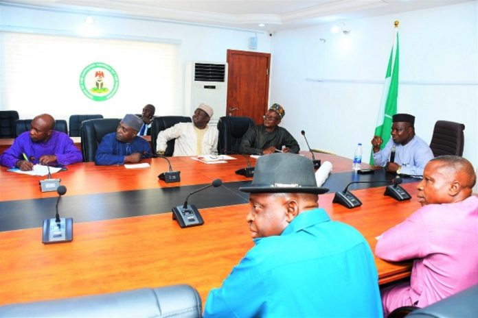 The SGoF, Surv. Adebomehin explaining certain salient areas on a projected Nigeria Administrative Map to the RMAFC team