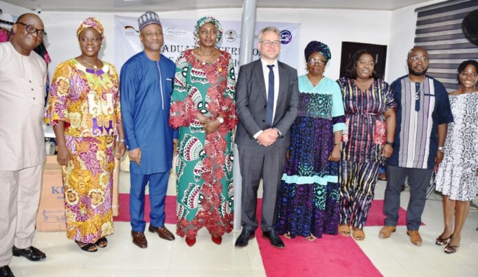 AFS Vocational Hub Permanent Secretary, Federal Ministry of Labour and Employment, Kachillom S. Daju, mni (4th left); GIZ representative, Markus Wauschkuhn (5th left); Deputy Director, Labour, Emmanuel Igbinosun (3rd left) with other guests at the graduation of 60 trainees at AFS Vocational Hub, in Abuja