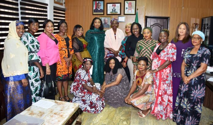 Courtsey visit to the Permanent Secretary Permanent Secretary, Federal Ministry of Labour and Employment, Ms Kachollom S. Daju, mni (meddle); President, Women Inspired Initiative, Loyce Ogueri (6th left) and other members of Women Inspired Initiative of the Ministry, during their visit to the Permanent Secretary, in Abuja