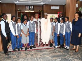 Minister of Defence, Major General Bahir Salihi Magashi (Rtd) pose with pupils of D-Pride International School, Garki, Abuja shortly after recording session of "Our World" a Television Series in Ship House, Abuja