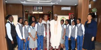 Minister of Defence, Major General Bahir Salihi Magashi (Rtd) pose with pupils of D-Pride International School, Garki, Abuja shortly after recording session of "Our World" a Television Series in Ship House, Abuja