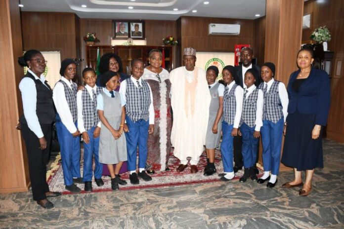 D-Pride International School Minister of Defence, Major General Bahir Salihi Magashi (Rtd) pose with pupils of D-Pride International School, Garki, Abuja shortly after recording session of "Our World" a Television Series in Ship House, Abuja
