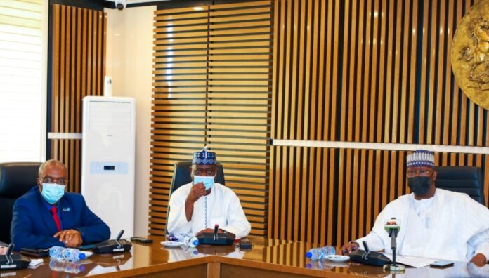 SGF, Boss Mustapha (R), DG NHIA, Prof. Mohammed Sambo (M) and WHO Country Representative to Nigeria, Dr. Walter Mulombo when the latter paid him a courtesy visit in his office