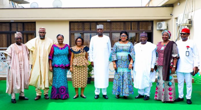 SGF, Boss Mustapha (M) in a group photograph with Chairman, White Paper Committee on the review of new Parastals, Agencies and Commissions, Engr_ Ebele Okeke (3rd R) with other members of the committee