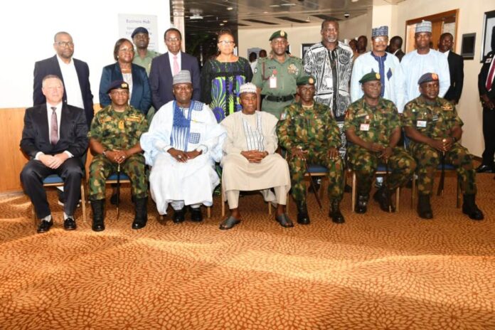group photograph at the workshop The Minister of Defence, Maj Gen Bashir Salihi Magashi (Rtd) (M), the Permanent Secretary, Dr Abubakar Kana, mni (3rd L) with the Chief of Defence Staff, Gen Lucky Irabor(3rd R) with the Service Chiefs and other stakeholders in a group photograph at the workshop in Transcorp Hilton Hotel, Abuja