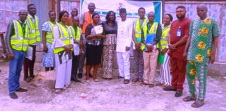 Representative of the Honourable Minister, Olajide Oshundun (6th right); Kogi State Labour Controller, Mrs Oluwatoyin Olugbami (7th right), with some of the participants at one of the training sites (fish farm) - Lokoja