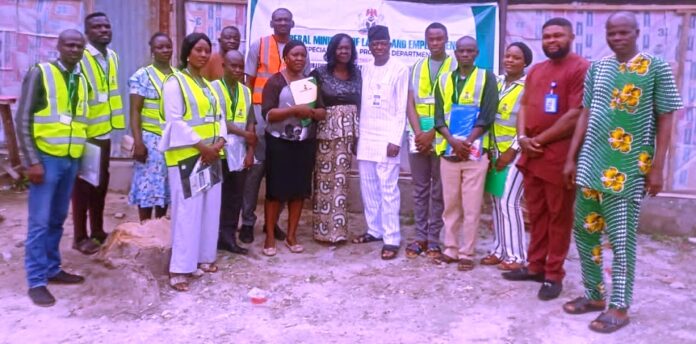 Representative of the Honourable Minister, Olajide Oshundun (6th right); Kogi State Labour Controller, Mrs Oluwatoyin Olugbami (7th right), with some of the participants at one of the training sites (fish farm) - Lokoja
