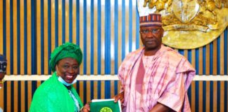 SGF, Boss Mustapha (L), receiving a document from President of National Council for Women Societies (NCWS), Hajiya Ladi Lau when the latter paid a courtesy call in his office