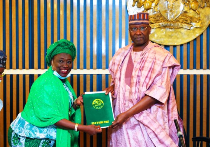 SGF, Boss Mustapha (L), receiving a document from President of National Council for Women Societies (NCWS), Hajiya Ladi Lau when the latter paid a courtesy call in his office