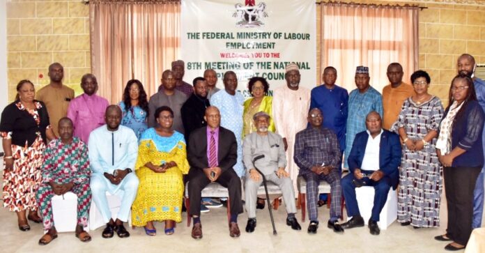 Sitting: Honourable Minister of Labour and Employment, Dr Chris Ngige, OON (3rd right); Director, Employment and Wages, Ministry of Labour, John Nyamali (4th right), and members of National Employment Council of Nigeria during their 8th meeting in Abuja