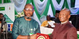 Mr. Ezeaja Ikemefuna, Assistant Director, Information Department, receiving Ministerial Services Award from the Hon. Minister of Agriculture and Rural Development, Dr. Mohammad Mahmood Abubakar in Abuja recently.