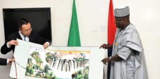 Permanent Secretary, Ministry of Defence, Dr Ibrahim Abubakar Kana, mni, receiving a souvenir from the leader of SASTIND delegation from China, Lin Yunteng, during the visit to Ship House, Abuja.